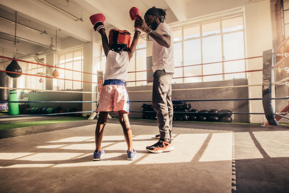 Boxing coach and young boy